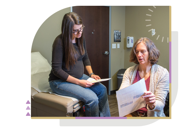 Female midwife-nurse with pregnant patient