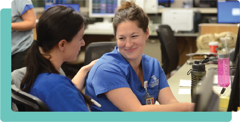 Two femail student nurses at hospital desk