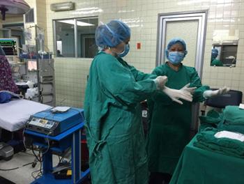 Nurses don scrubs and gloves in an operating room in Ecuador