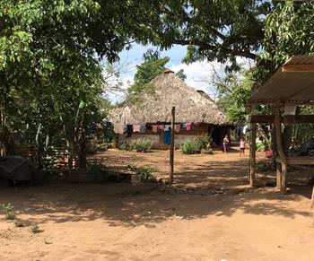 The entrance to a Guatemalan village with a hut in the background