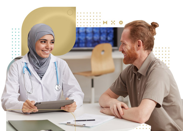 Muslim doctor using tablet pc and talking with male patient while they sitting at the table during his visit at hospital