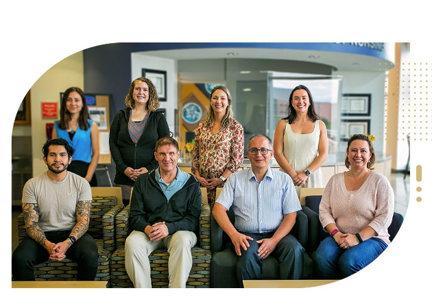 Student researchers and professor in group setting