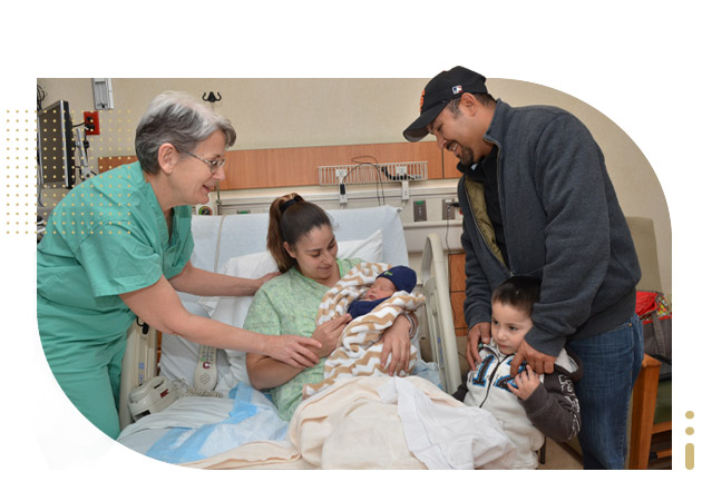 Nurse-midwife, mother, father and child look at newborn baby