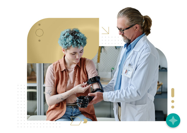 Senior nurse consulting young woman and fitting prosthetic arm in orthology clinic