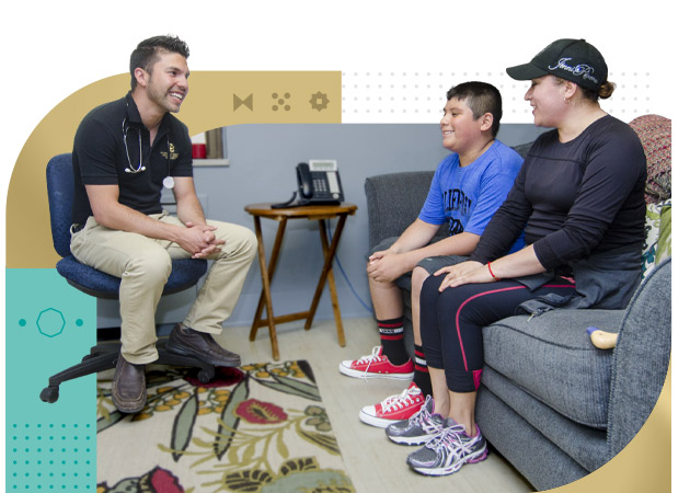 Male nurse consults with teen boy and mother in clinic