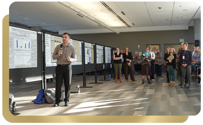 Male college student showing a poster presentation