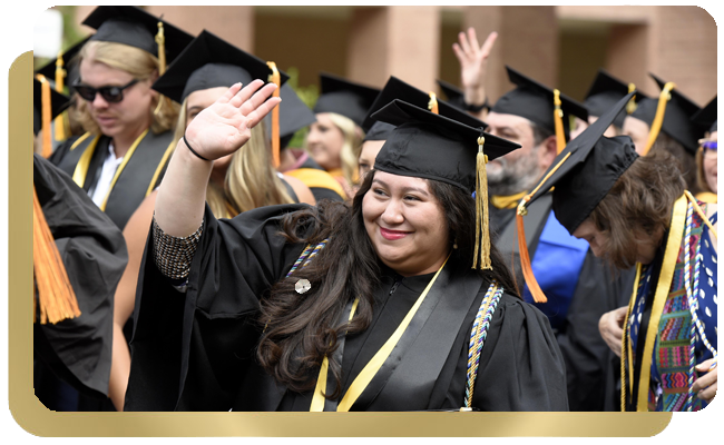 College graduates wave to friends and family