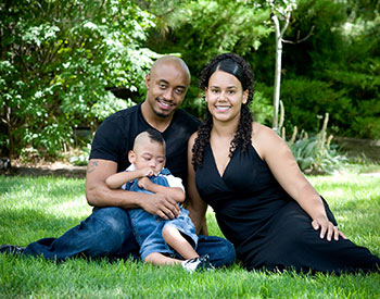 Karina and her family posing for a portrait on the grass
