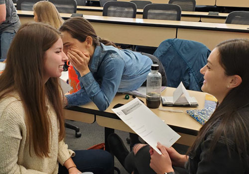 Students take part in a “hearing voices” activity that one instructor said many people find “unsettling” and “eye-opening.”