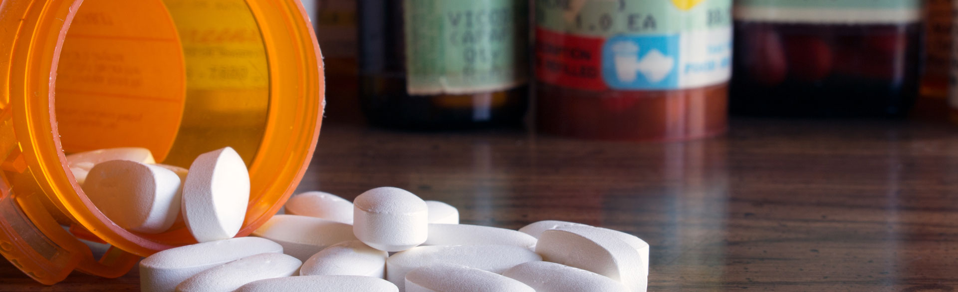 A vial of medication spilled out on the table