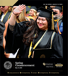 Female graduate in graduation attire waving to crowd
