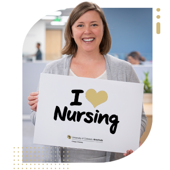 Student nurse holding 'I Am A CU Nurse' sign