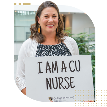 Student nurse holding 'I Am A CU Nurse' sign