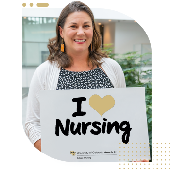 Student nurse holding 'I Am A CU Nurse' sign