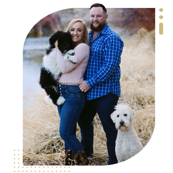 Woman and husband with two dogs along a river