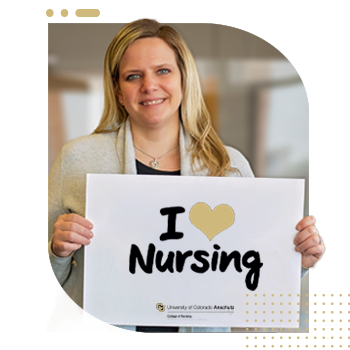 Student nurse holding 'I Am A CU Nurse' sign