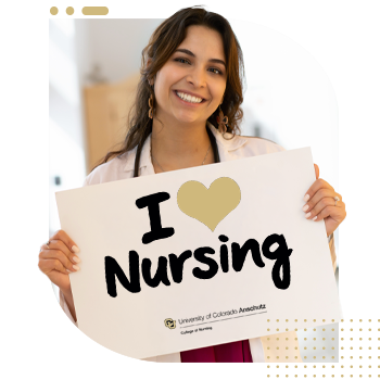 Student nurse holding 'I Am A CU Nurse' sign