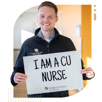 Student nurse holding 'I Am A CU Nurse' sign