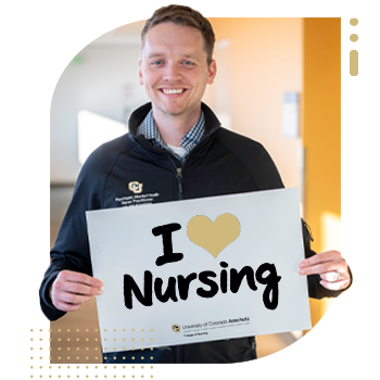 Student nurse holding 'I Am A CU Nurse' sign