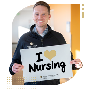 Student nurse holding 'I Am A CU Nurse' sign