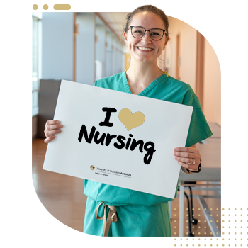 Student nurse holding 'I Am A CU Nurse' sign